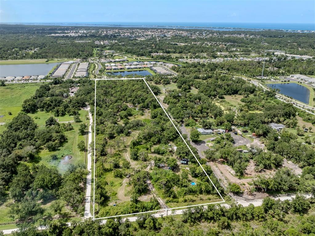 East Manasota Beach Road Englewood, FL 34223 - Photo 7 of 65 an aerial view of a residential houses with outdoor space and trees
