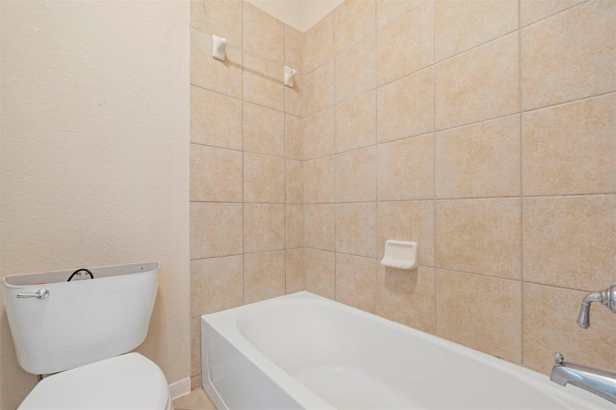 3 Etude Court Spring, TX 77382 - Photo 25 of 45 a white bath tub sitting next to a white toilet