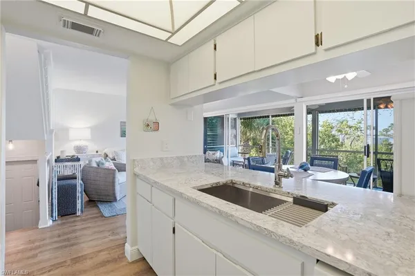 a kitchen with sink cabinets and wooden floor