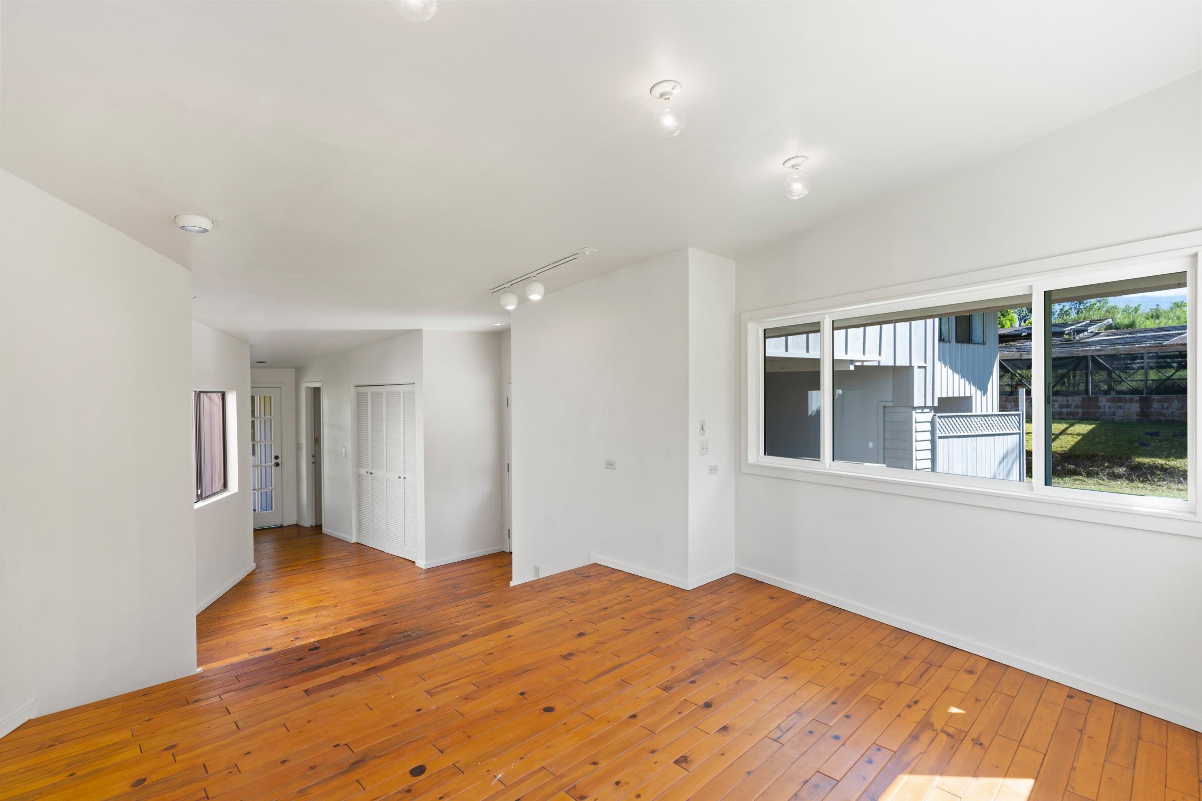 575 Awalau Road Haiku, HI 96708 - Photo 18 of 50 a bedroom with a bed and a window