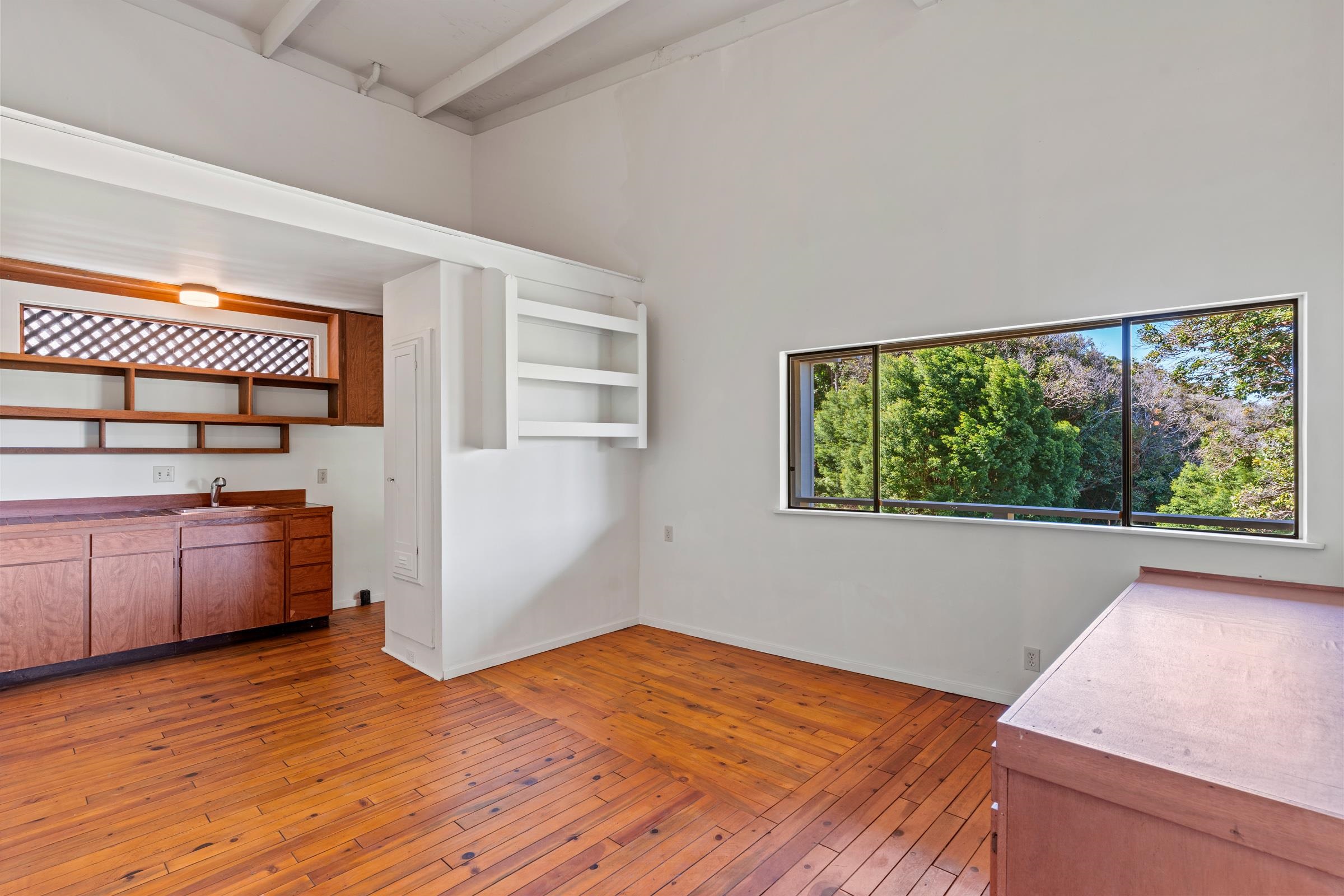 575 Awalau Road Haiku, HI 96708 - Photo 21 of 50 a view of a room with wooden floor and furniture