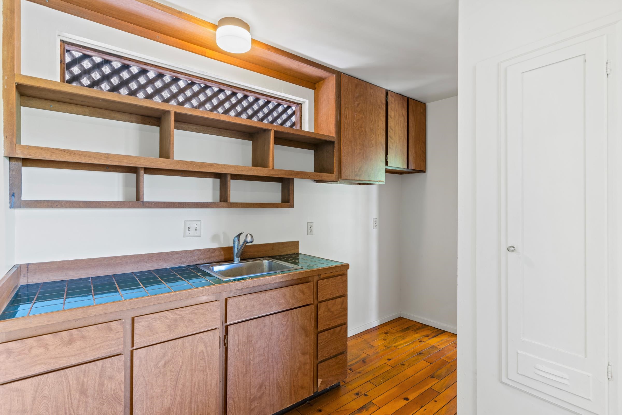 575 Awalau Road Haiku, HI 96708 - Photo 24 of 50 a kitchen with a sink and cabinets