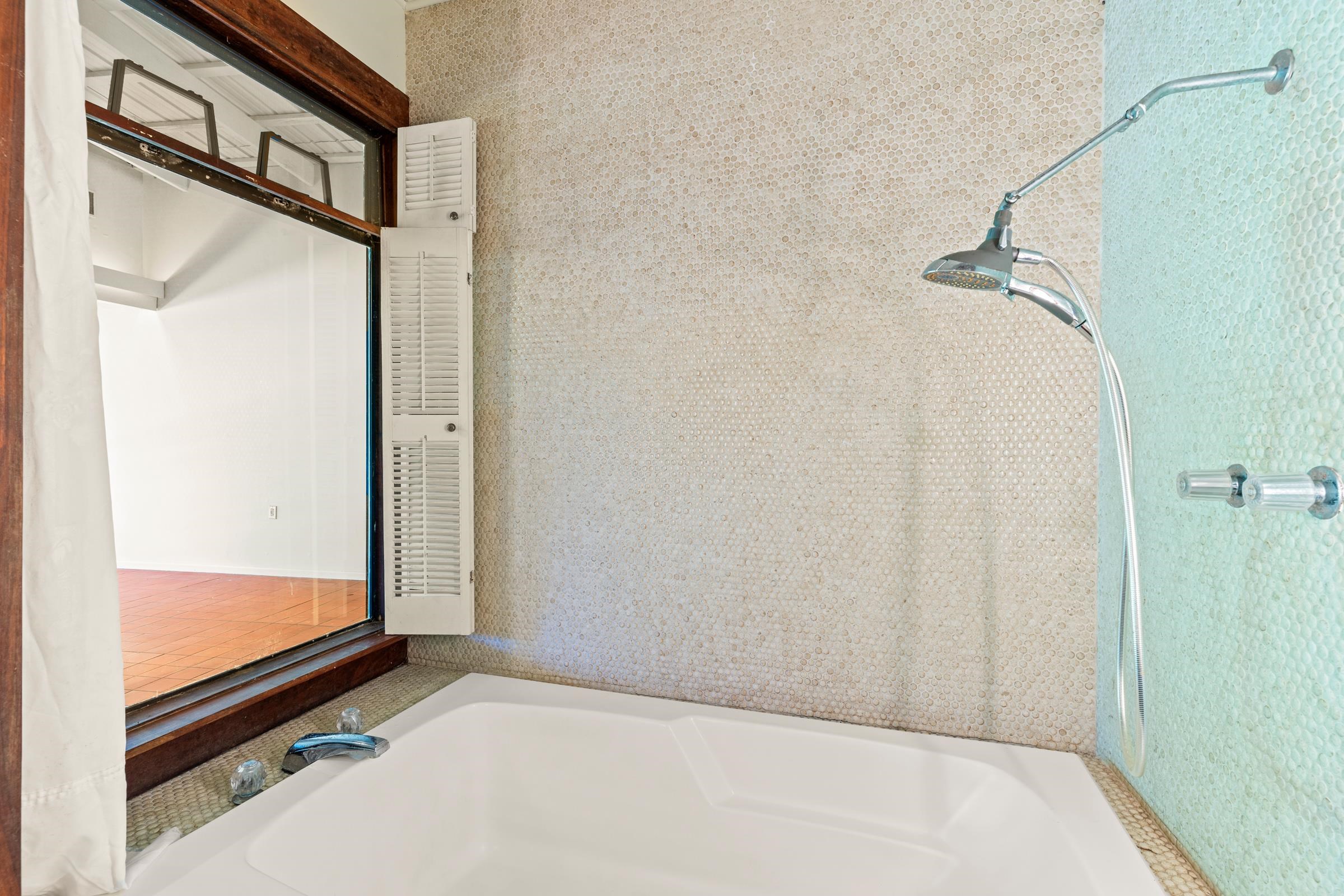 575 Awalau Road Haiku, HI 96708 - Photo 26 of 50 a bathroom with a glass shower door