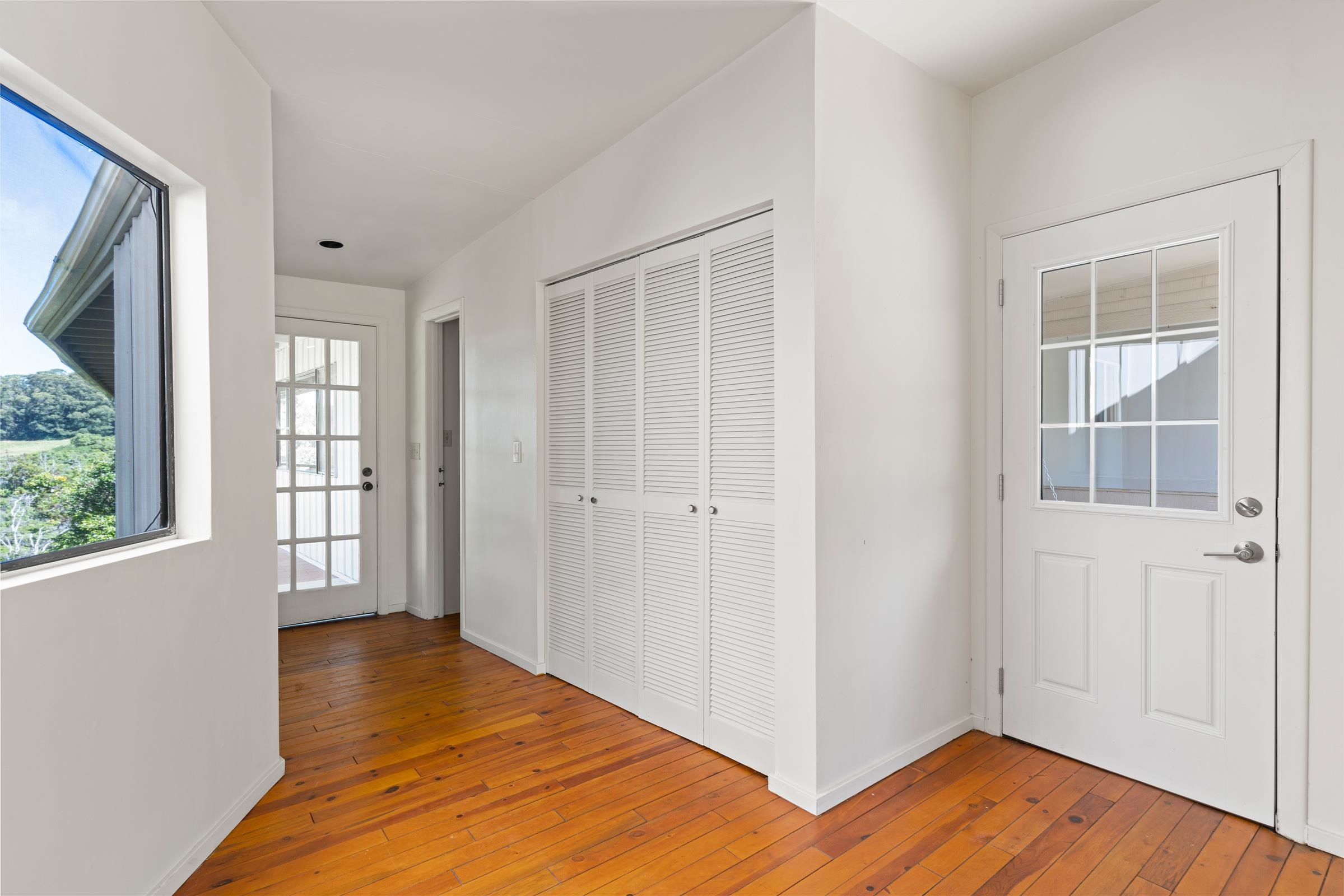 575 Awalau Road Haiku, HI 96708 - Photo 32 of 50 a view of a room with wooden floor and windows