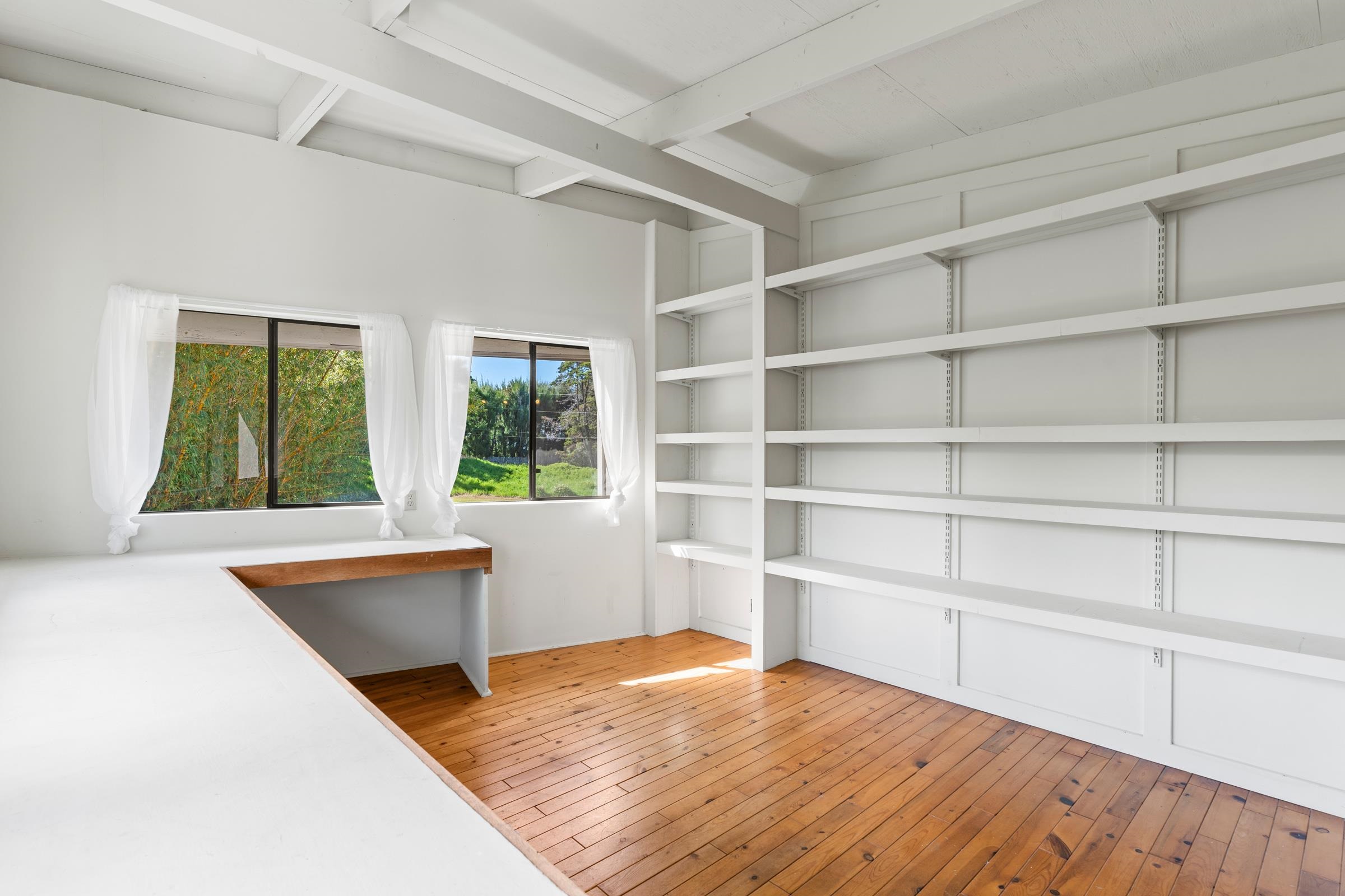 575 Awalau Road Haiku, HI 96708 - Photo 34 of 50 a view of an empty room with a window and wooden floor