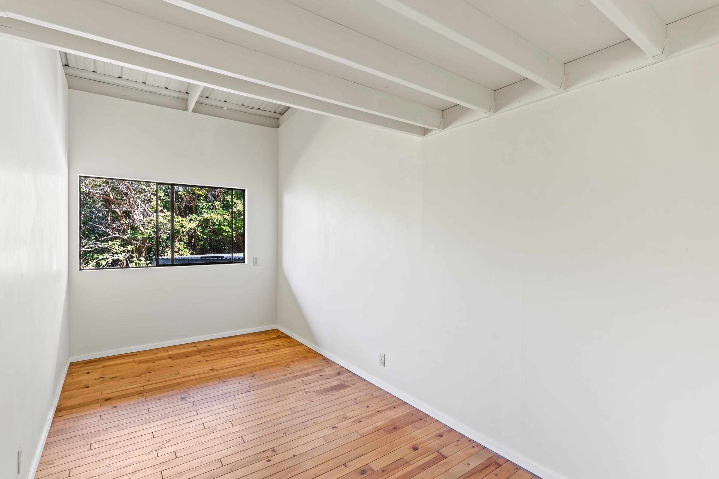 575 Awalau Road Haiku, HI 96708 - Photo 37 of 50 a view of a room with wooden floor and small window