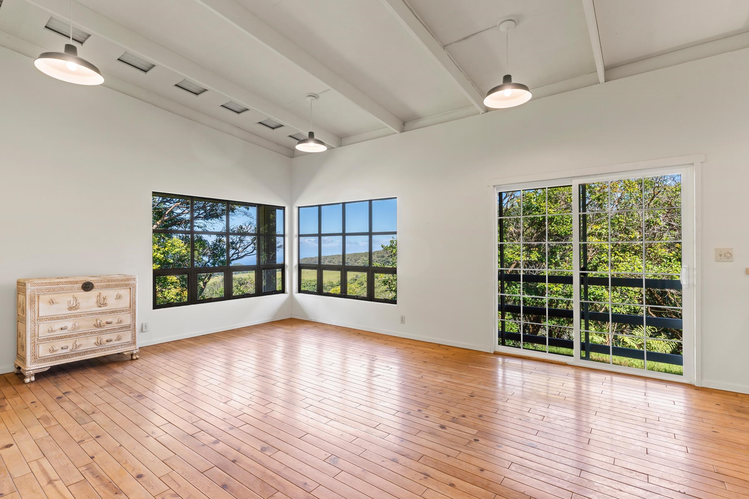 575 Awalau Road Haiku, HI 96708 - Photo 4 of 50 wooden floor in an empty room with a window