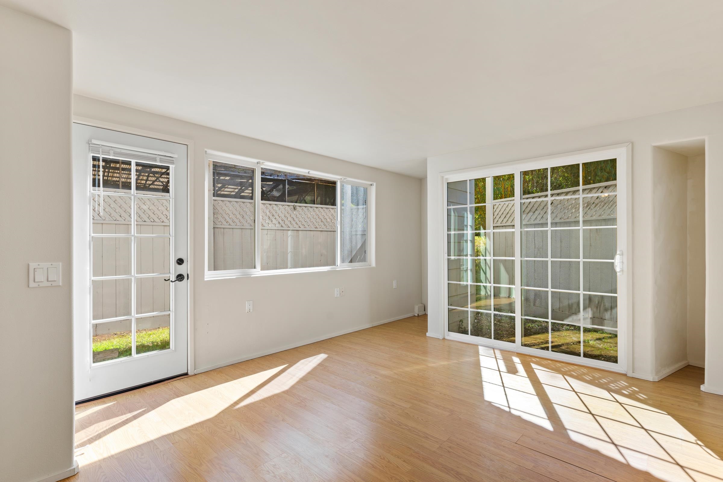 575 Awalau Road Haiku, HI 96708 - Photo 43 of 50 an empty room with wooden floor and windows