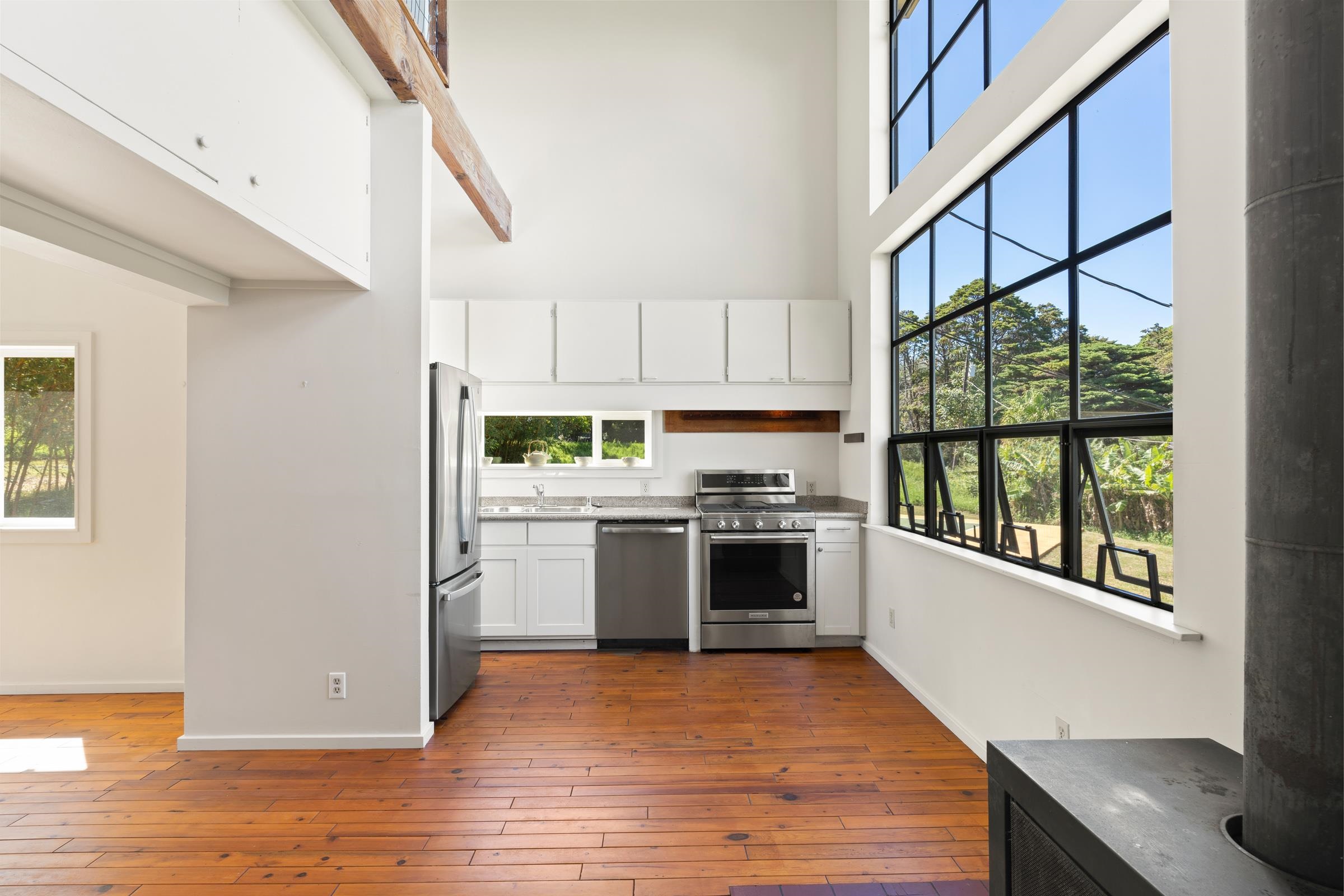 575 Awalau Road Haiku, HI 96708 - Photo 8 of 50 a kitchen with a refrigerator and a stove top oven