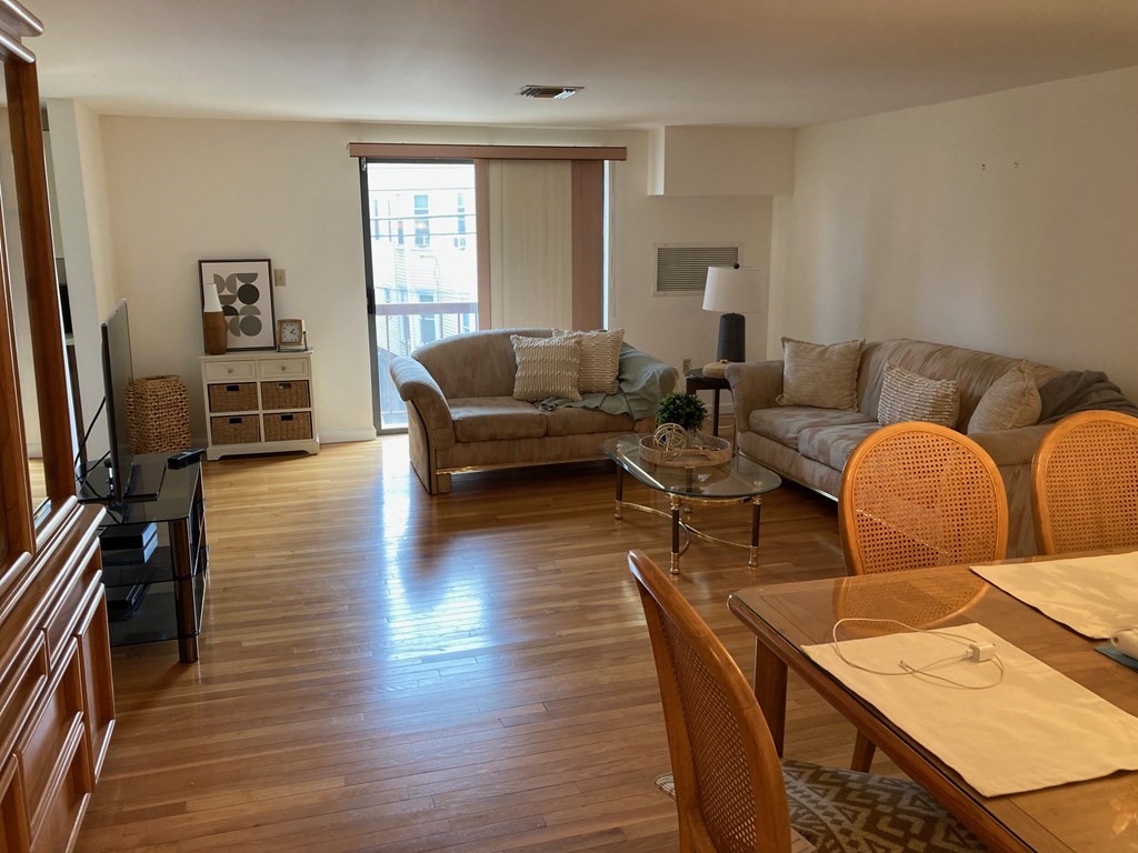 72 School Street, Unit 5 Everett, MA 02149 - Photo 1 of 21 a living room with furniture and wooden floor