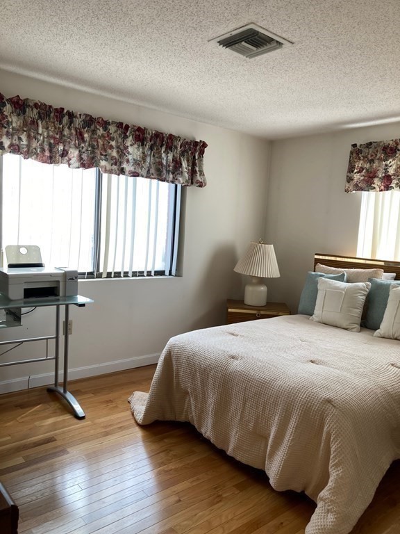 72 School Street, Unit 5 Everett, MA 02149 - Photo 12 of 21 a bedroom with a bed and window