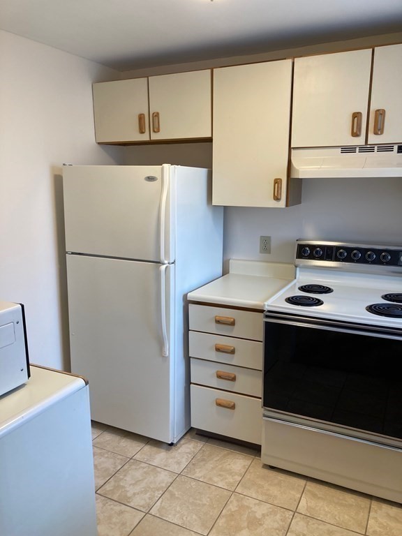 72 School Street, Unit 5 Everett, MA 02149 - Photo 13 of 21 a kitchen with cabinets and a stove top oven
