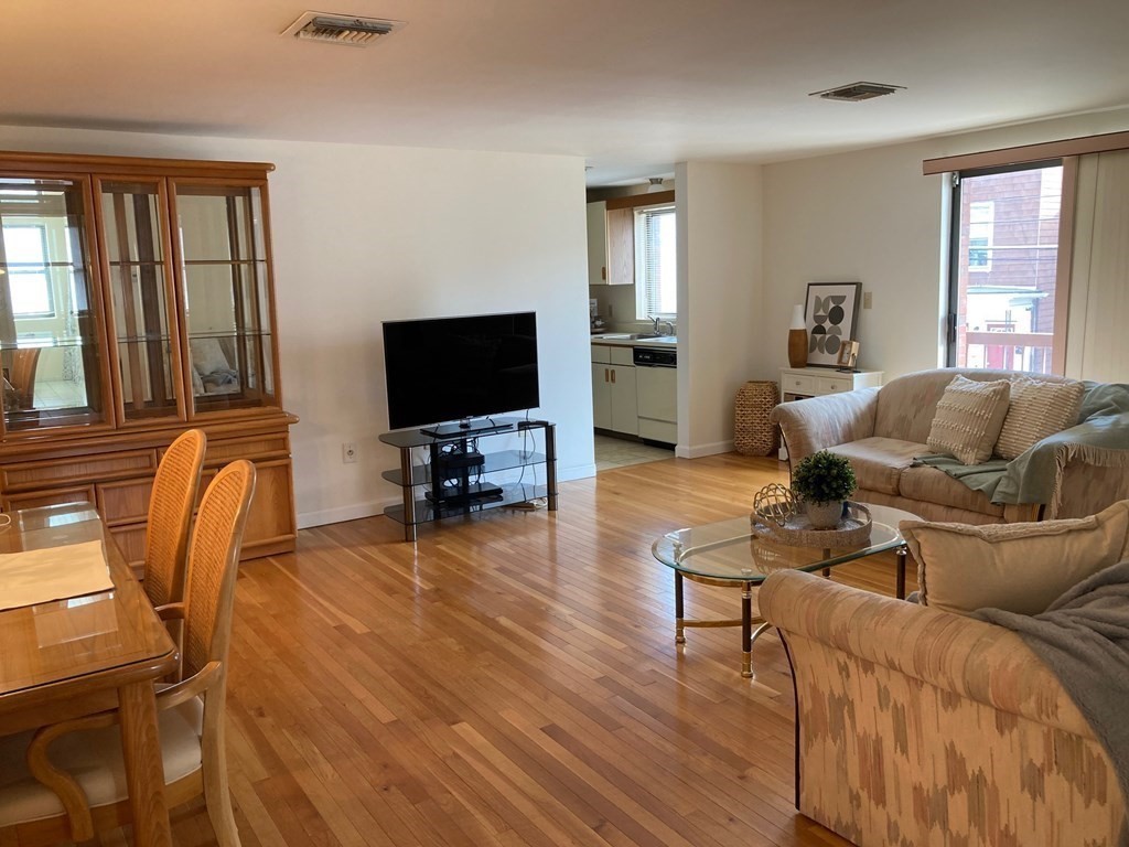 72 School Street, Unit 5 Everett, MA 02149 - Photo 2 of 21 a living room with furniture and a flat screen tv