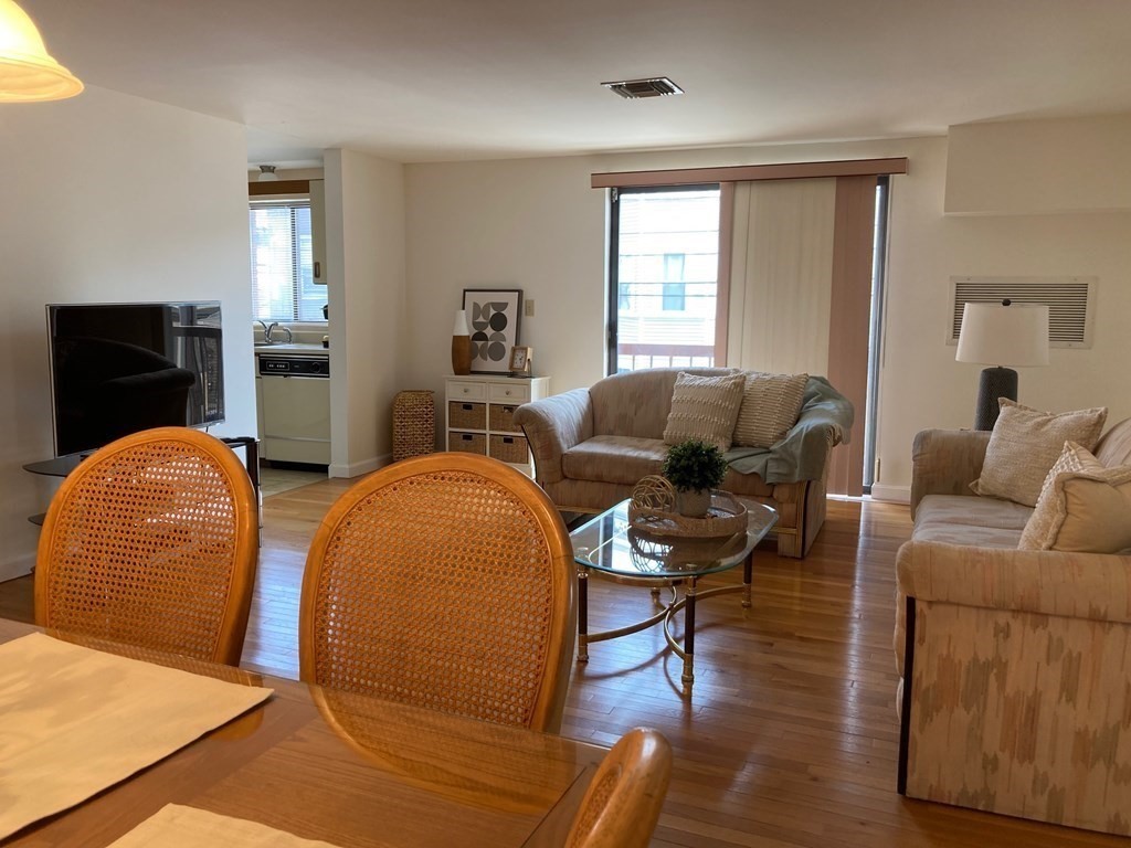72 School Street, Unit 5 Everett, MA 02149 - Photo 3 of 21 a living room with furniture and wooden floor