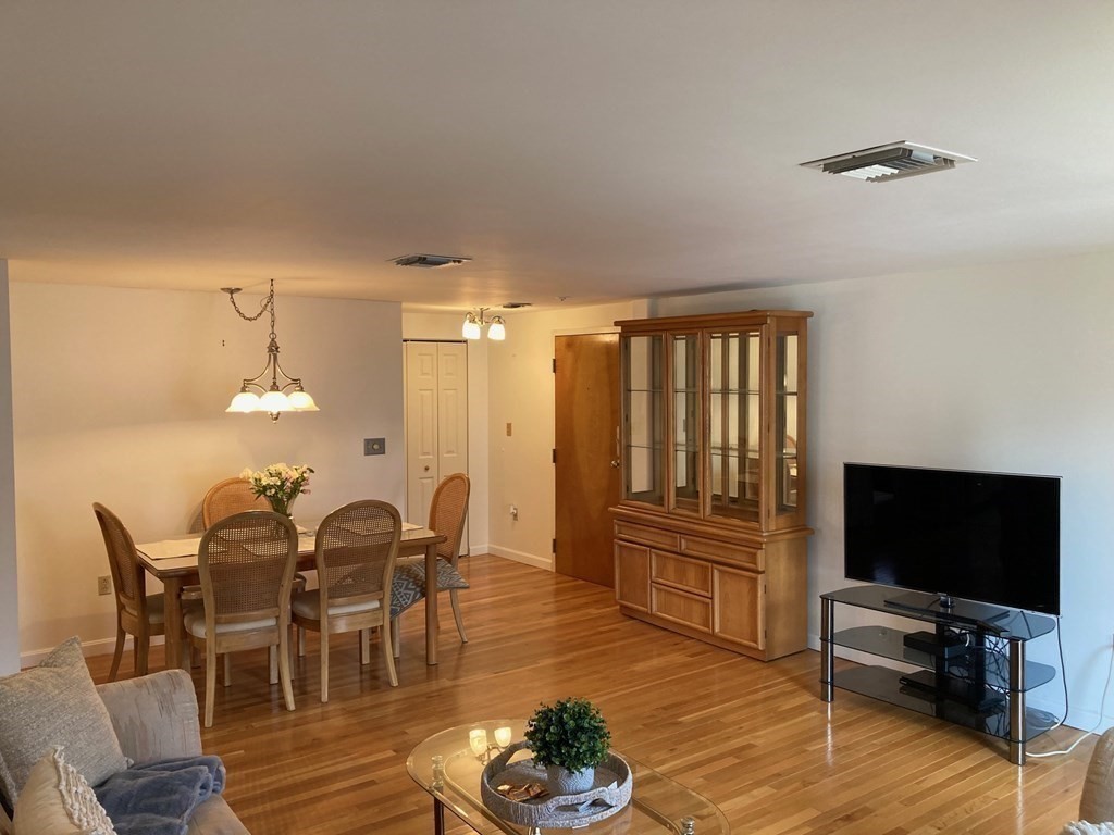 72 School Street, Unit 5 Everett, MA 02149 - Photo 4 of 21 a view of a dining room with furniture window and wooden floor