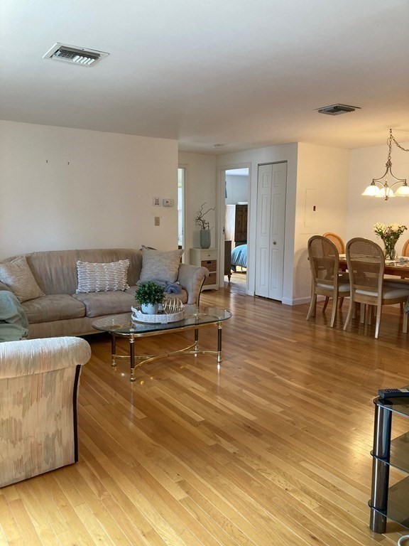 72 School Street, Unit 5 Everett, MA 02149 - Photo 5 of 21 a living room with furniture and wooden floor