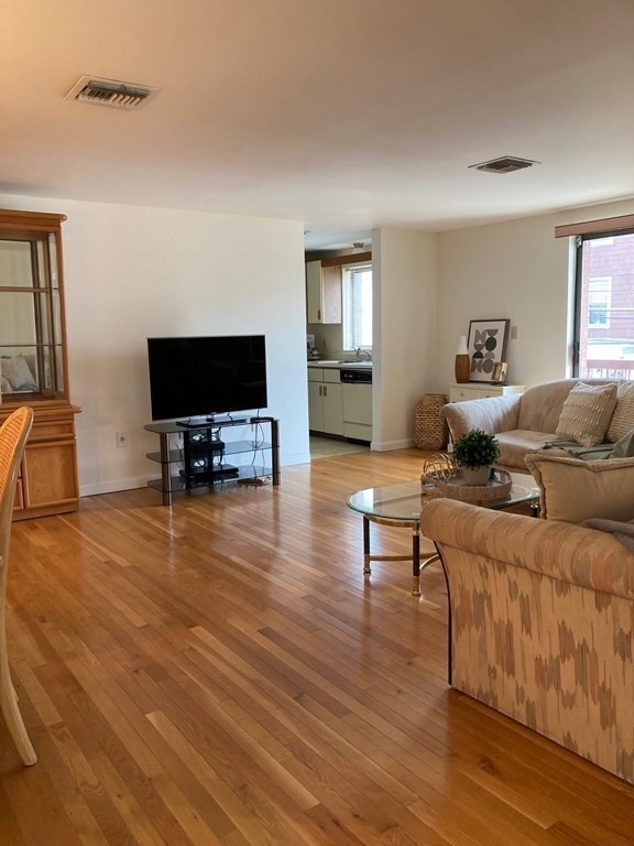 72 School Street, Unit 5 Everett, MA 02149 - Photo 7 of 21 a living room with furniture and a flat screen tv