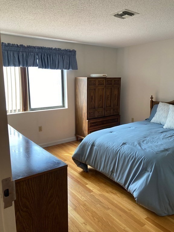 72 School Street, Unit 5 Everett, MA 02149 - Photo 8 of 21 a bedroom with a bed and window