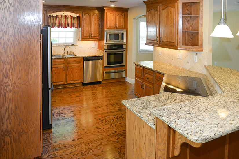 7 Elkwood Court Shalimar, FL 32579 - Photo 2 of 23 a kitchen with stainless steel appliances granite countertop a sink stove and refrigerator