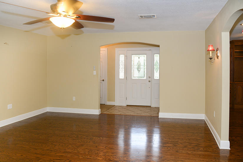7 Elkwood Court Shalimar, FL 32579 - Photo 8 of 23 an empty room with wooden floor fan and windows
