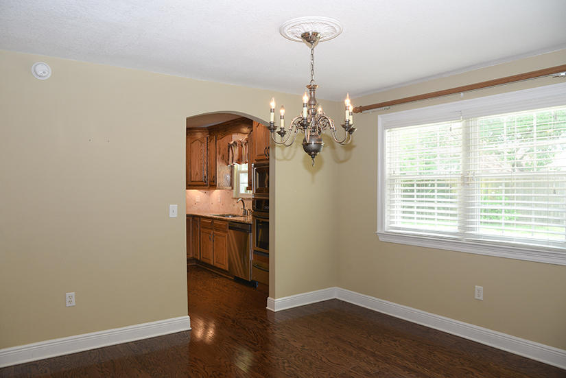 7 Elkwood Court Shalimar, FL 32579 - Photo 10 of 23 a room with wooden floor chandelier and kitchen view