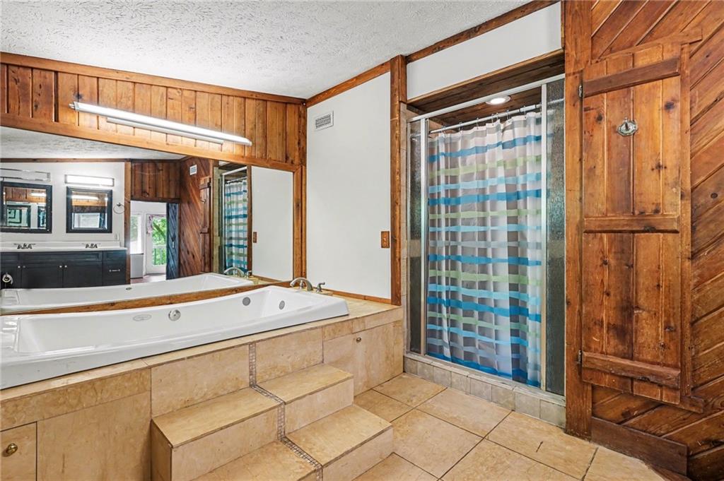 2530 Rockbridge Road Northwest Conyers, GA 30012 - Photo 24 of 45 a spacious bathroom with a shower and a sink