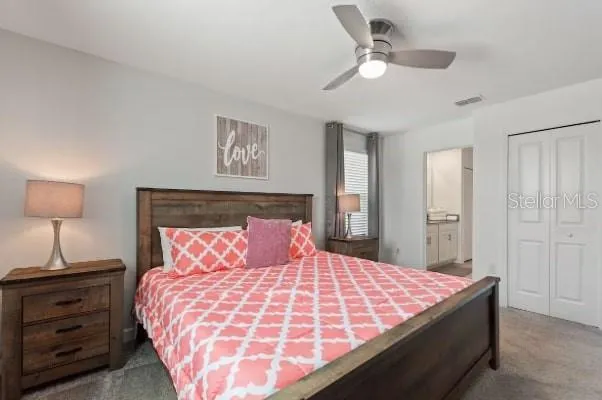 a bedroom with a bed and a lamp