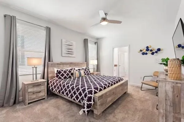 a bed sitting in a bedroom next to a window and a chandelier