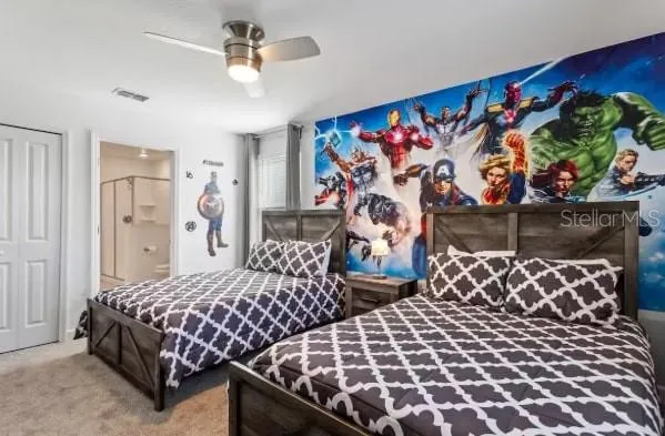 a bedroom with three large bed and a window