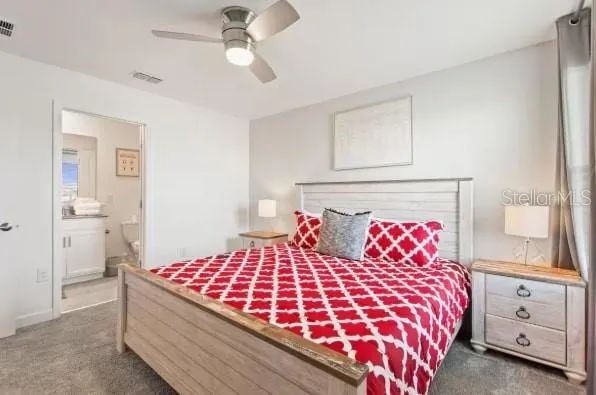 a bedroom with a large bed and a chandelier