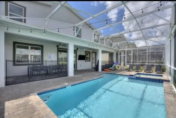 a view of a house with backyard porch and sitting area