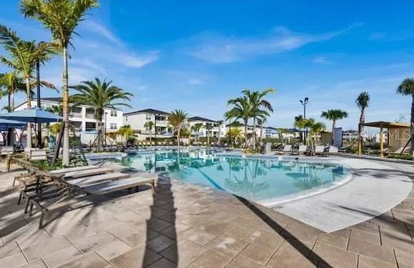 a view of swimming pool with outdoor seating and plants