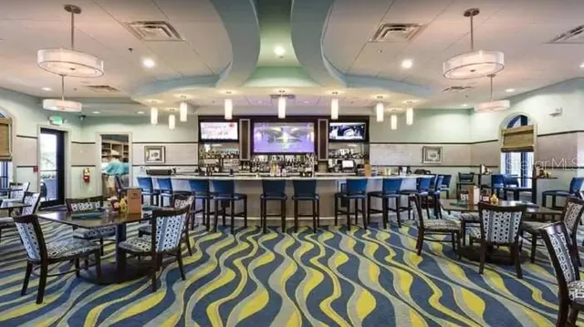 a room with lots of chairs and wooden floor