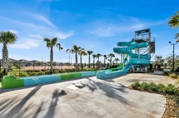 a front view of a house with a yard and potted plants