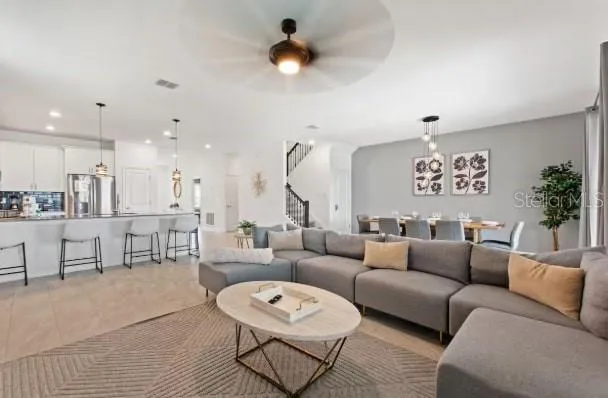 a living room with furniture a rug and a chandelier