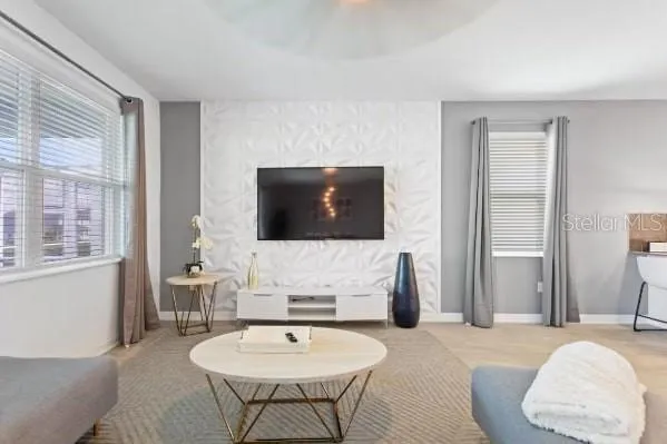 a living room with furniture and a flat screen tv