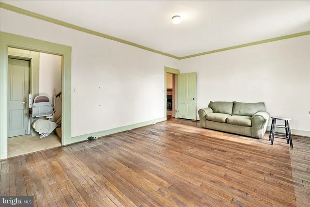 a living room with a large window and furniture