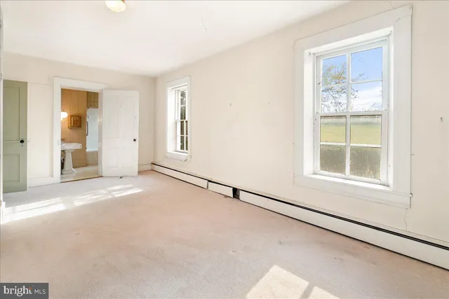 a view of a field of grass and trees