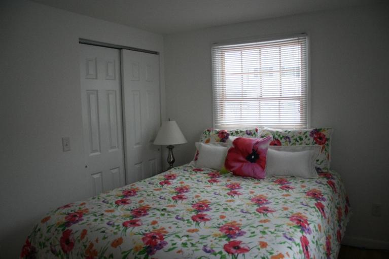 26 Locust Road, Unit 26 Eastham, MA 02642 - Photo 10 of 16 a bedroom with a bed and window