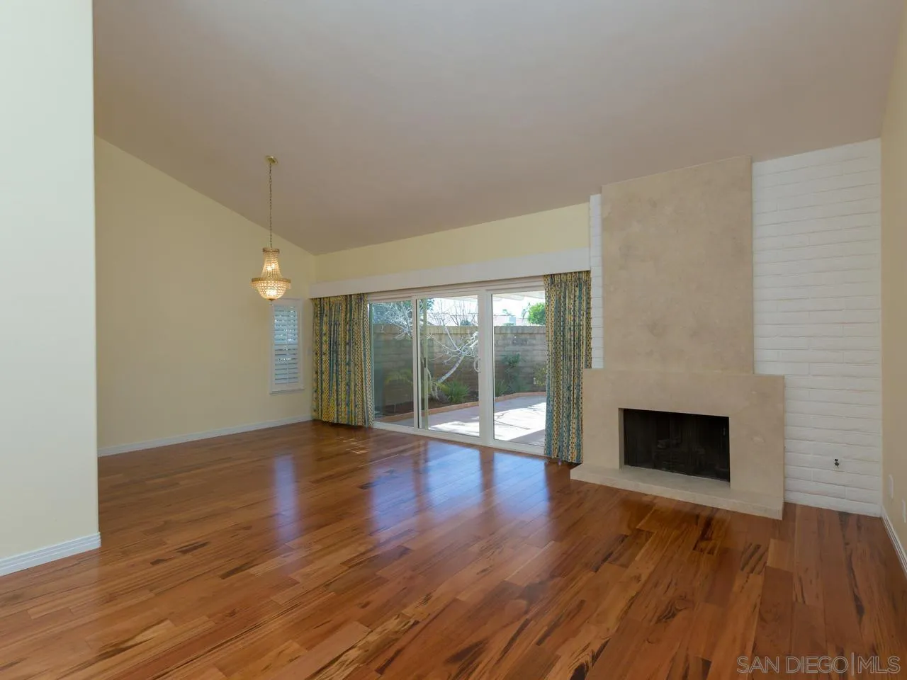 1804 Caminito Ascua La Jolla, CA 92037 - Photo 16 of 20 a view of empty room with wooden floor and fireplace