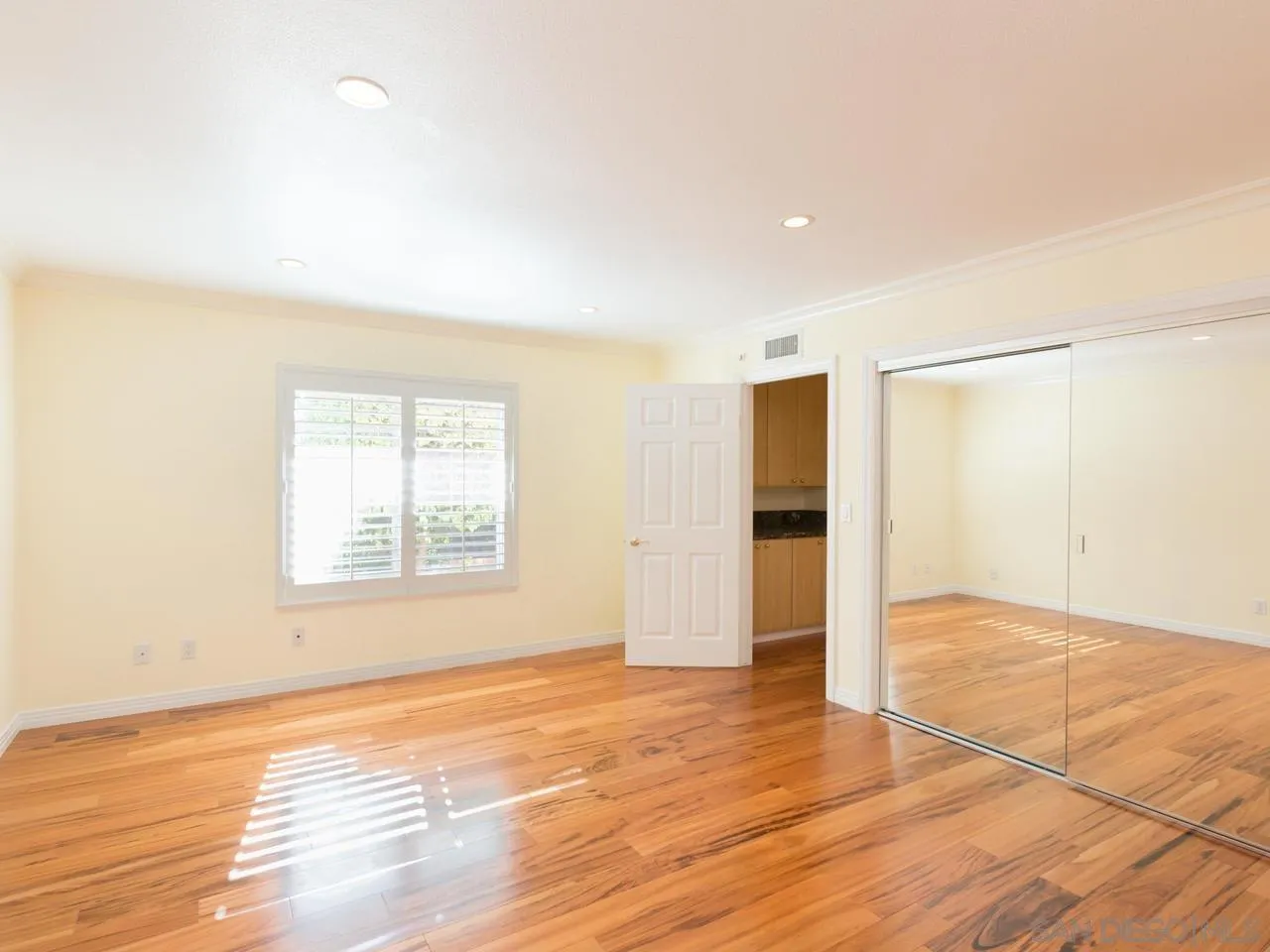 1804 Caminito Ascua La Jolla, CA 92037 - Photo 18 of 20 an empty room with wooden floor and windows