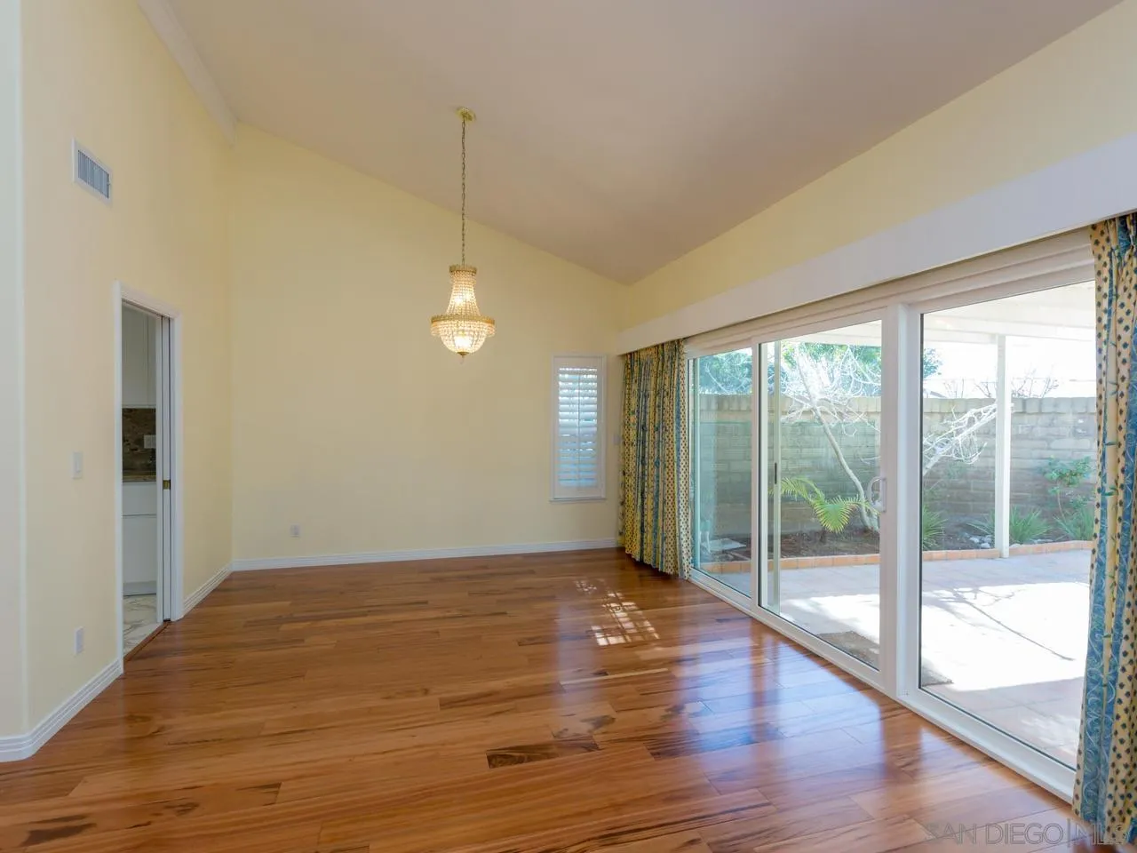 1804 Caminito Ascua La Jolla, CA 92037 - Photo 5 of 20 a view of an empty room with wooden floor and a window