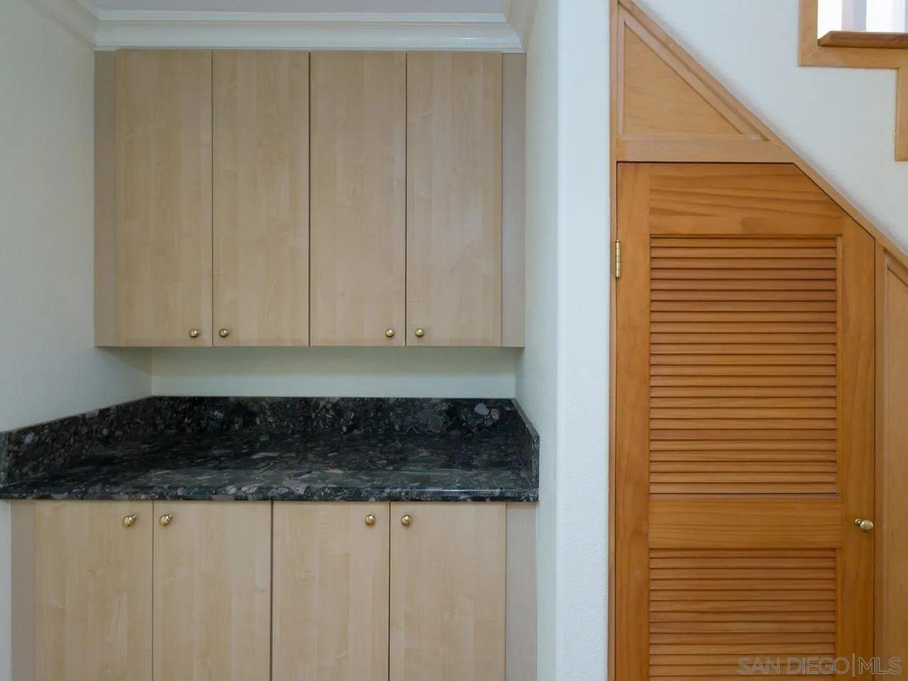 1804 Caminito Ascua La Jolla, CA 92037 - Photo 8 of 20 a bathroom with a granite countertop sink and a white cabinets