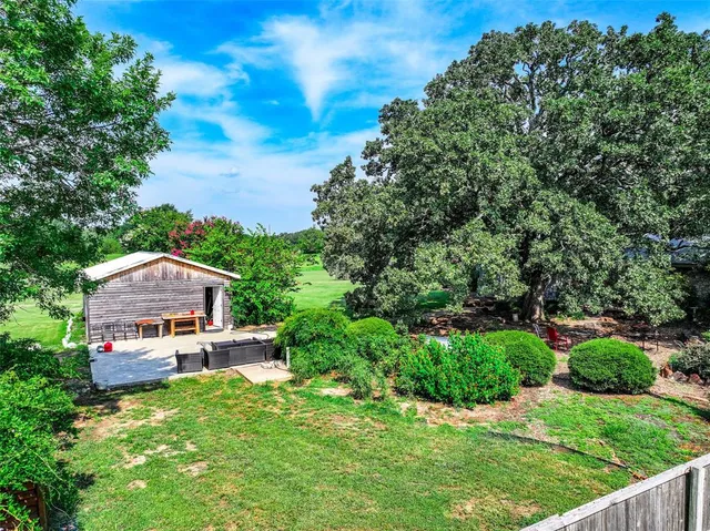 a view of a park with large trees