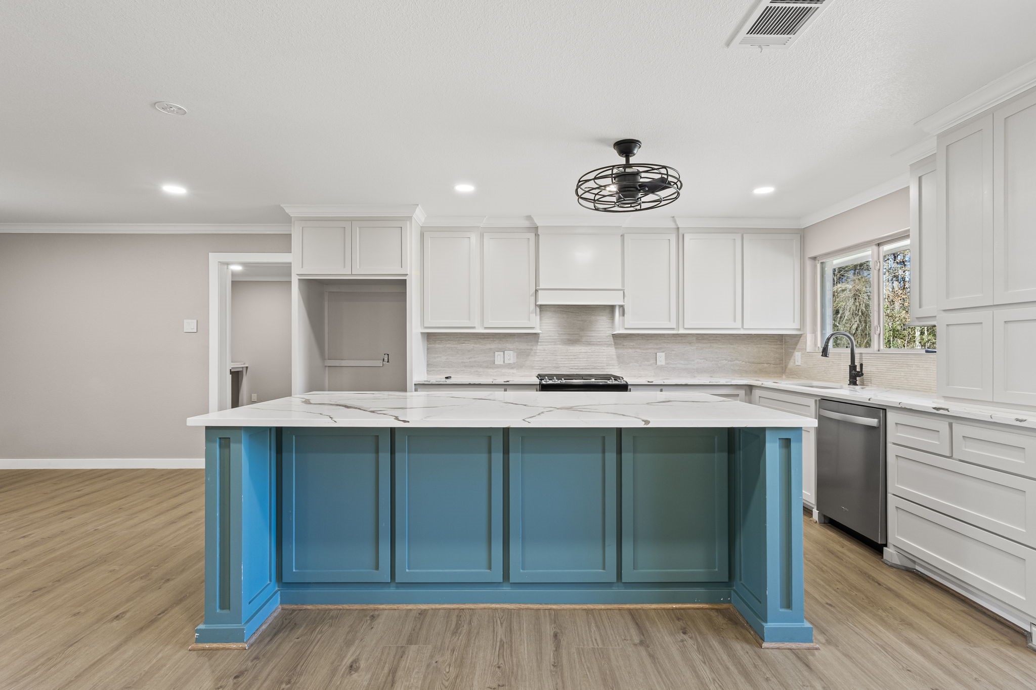 44271 Highway 105 Hull, TX 77564 - Photo 11 of 38 a kitchen with stainless steel appliances granite countertop a sink cabinets and wooden floor