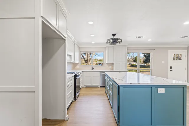 a kitchen with stainless steel appliances granite countertop a sink and cabinets