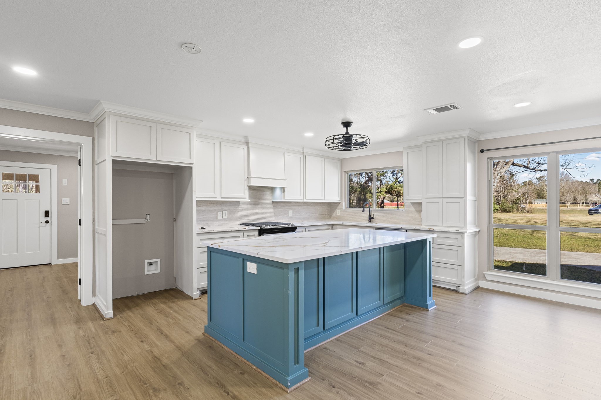 44271 Highway 105 Hull, TX 77564 - Photo 14 of 38 a kitchen with a stove a refrigerator a sink and a oven with wooden floor