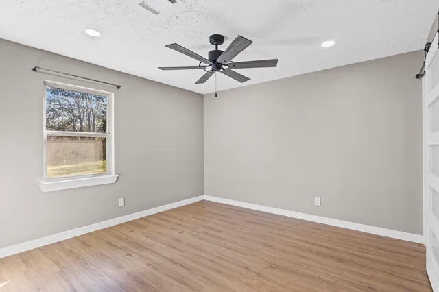 wooden floor in an empty room with a window