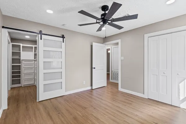 a view of a livingroom with a hardwood floor and a ceiling fan