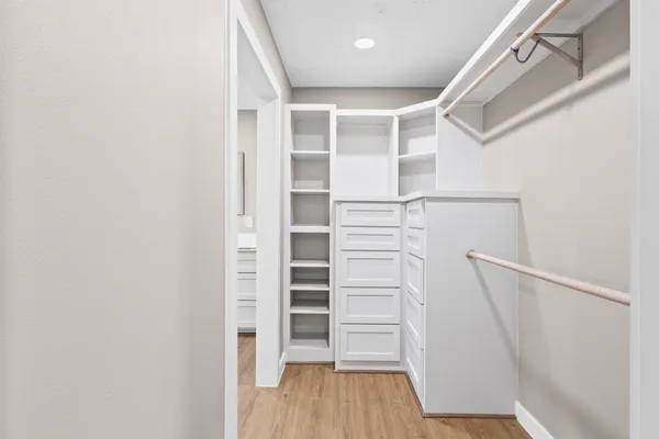 a view of walk in closet with empty racks